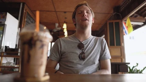 Young Guy in Cafe Chatting With Friend Stock Footage 126574800