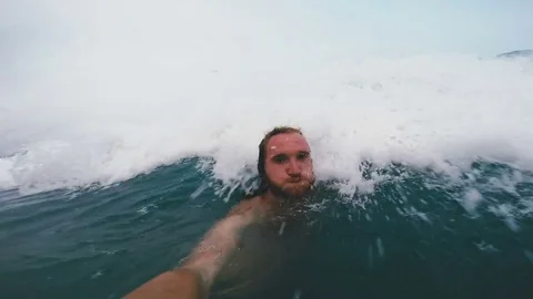 Young guy catches a wave Stock Footage 80534924