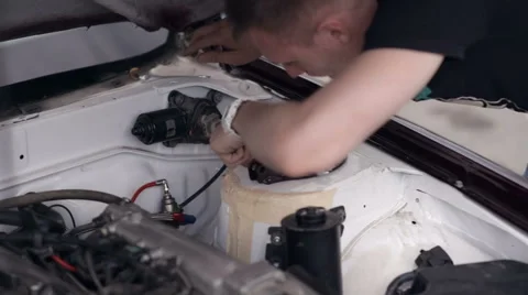 Young guy checks the engine of his car Stock Footage 68012830