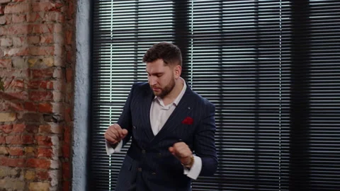 A young guy in a classic suit dances and money rains on him. Concept of success Stock Footage 170598434