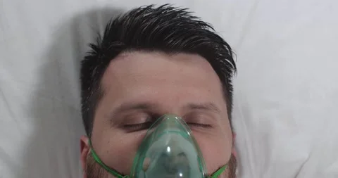 Young guy closing his eyes in a hospital bed 動画素材 166728010
