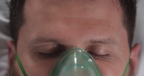 Young guy closing his eyes in a hospital bed Stock Footage 166728209