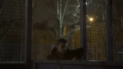 Young guy in a coat moves on the platform Stock Footage 77377427