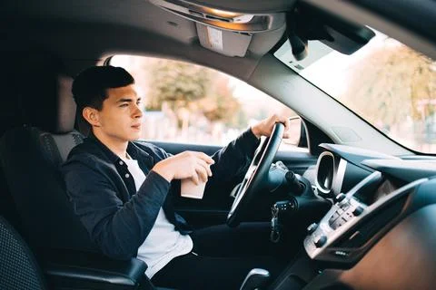 A young guy with a coffee drive while travel Stock Photos
