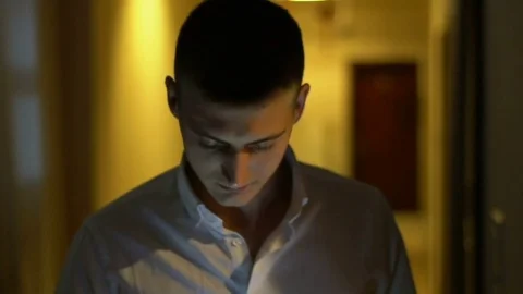 A young guy comes up and calls Stock Footage 72197347