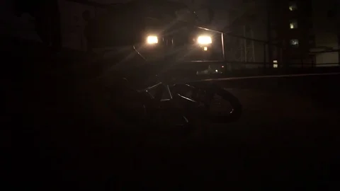 Young guy comes out of a minibus and jumps over a fence next to which bicycles Video stock 103044565