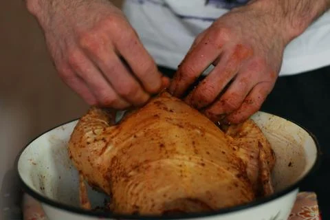 The young guy is cooking big chicken Stock Photos
