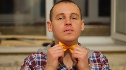 Young guy corrects the orange tie Stock Footage 69745658