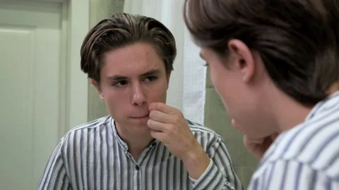 Young guy crushes pimples. Awkward age. Problems with the skin. Dermatology Stock-Footage 140995383