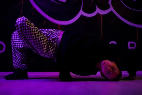 Young guy dancer break dance shows his skill. doing an exercise. Stock Photos