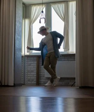 Young guy dancer in motion in a pose. A man performs a modern dance in casu.. Stock Photos
