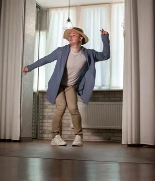 Young guy dancer in motion in a pose. A man performs a modern dance in casu.. Stock Photos