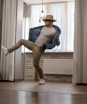 Young guy dancer in motion in a pose. A man performs a modern dance in casu.. Photos