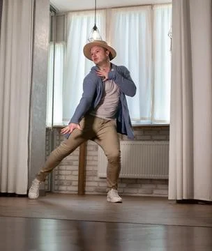 Young guy dancer in motion in a pose. A man performs a modern dance in casu.. Stock Photos