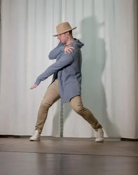 Young guy dancer in motion in a pose. A man performs a modern dance in casu.. Stock Photos