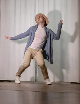 Young guy dancer in motion in a pose. A man performs a modern dance in casu.. Stock Photos