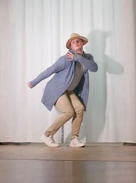 Young guy dancer in motion in a pose. A man performs a modern dance in casu.. Stock Photos