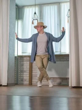 Young guy dancer in motion in a pose. A man performs a modern dance in casu.. Stock Photos