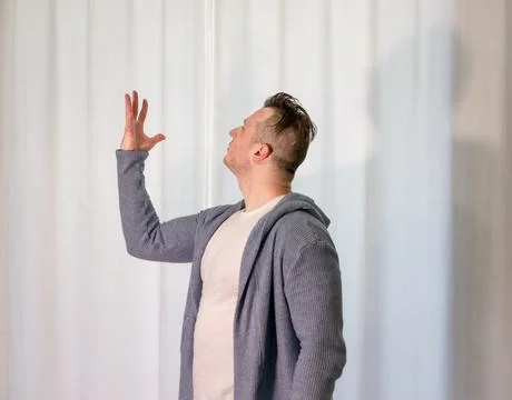 Young guy dancer in motion in a pose. A man performs a modern dance in casu.. Stock Photos