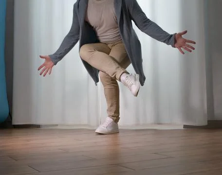 Young guy dancer in motion in a pose. A man performs a modern dance in casu.. Stock Photos