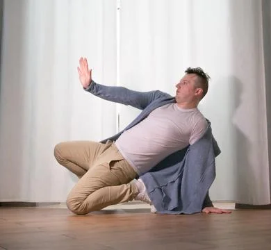 Young guy dancer in motion in a pose. A man performs a modern dance in casu.. Stock Photos