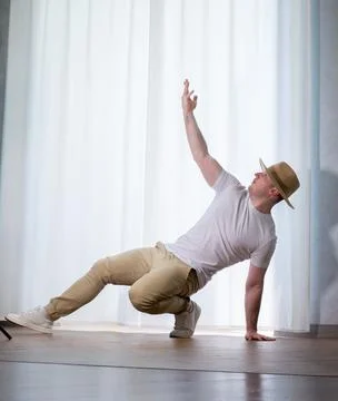 Young guy dancer in motion in a pose. A man performs a modern dance in casu.. Stock Photos