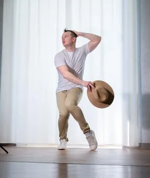 Young guy dancer in motion in a pose. A man performs a modern dance in casu.. Stock Photos