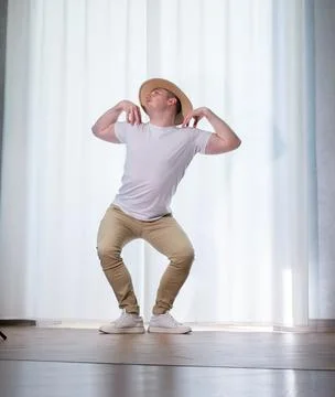 Young guy dancer in motion in a pose. A man performs a modern dance in casu.. Stock Photos