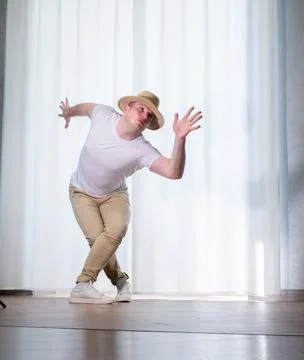 Young guy dancer in motion in a pose. A man performs a modern dance in casu.. Stock Photos