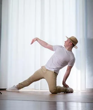 Young guy dancer in motion in a pose. A man performs a modern dance in casu.. Stock Photos