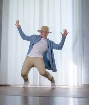 Young guy dancer in motion in a pose. A man performs a modern dance in casu.. Stock Photos