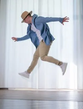 Young guy dancer in motion in a pose. A man performs a modern dance in casu.. Stock Photos