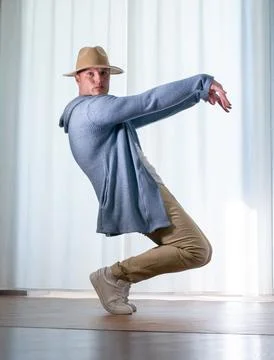 Young guy dancer in motion in a pose. A man performs a modern dance in casu.. Stock Photos