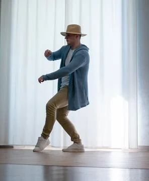 Young guy dancer in motion in a pose. A man performs a modern dance in casu.. Photos