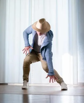 Young guy dancer in motion in a pose. A man performs a modern dance in casu.. Stock Photos