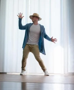 Young guy dancer in motion in a pose. A man performs a modern dance in casu.. Stock Photos
