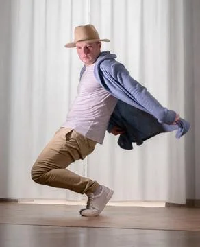 Young guy dancer in motion in a pose. A man performs a modern dance in casu.. Stock Photos