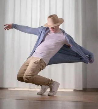 Young guy dancer in motion in a pose. A man performs a modern dance in casu.. Stock Photos