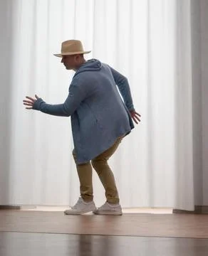 Young guy dancer in motion in a pose. A man performs a modern dance in casu.. Stock Photos