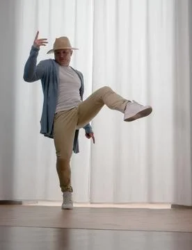 Young guy dancer in motion in a pose. A man performs a modern dance in casu.. Stock Photos