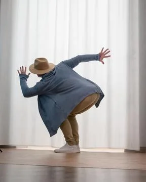 Young guy dancer in motion in a pose. A man performs a modern dance in casu.. Stock Photos