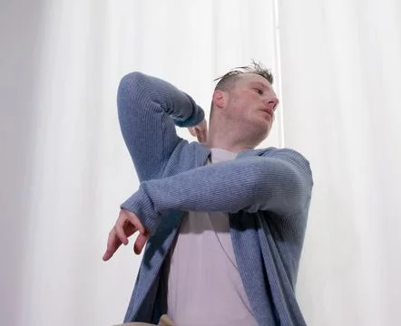 Young guy dancer in motion in a pose. A man performs a modern dance in casu.. Stock Photos