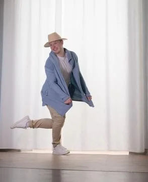 Young guy dancer in motion in a pose. A man performs a modern dance in casu.. Stock Photos