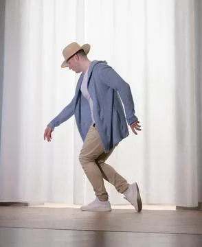 Young guy dancer in motion in a pose. A man performs a modern dance in casu.. Stock Photos