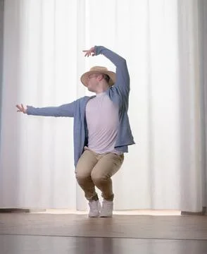 Young guy dancer in motion in a pose. A man performs a modern dance in casu.. Stock Photos