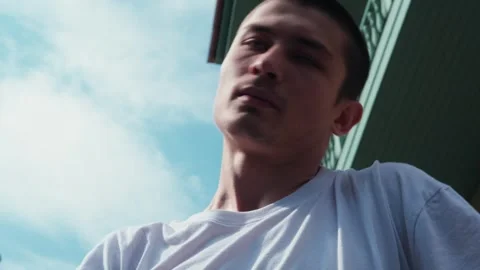 A young guy dances against the background of an authentic city landscape.  Stock Footage 242147822