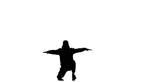 Young guy dancing hip hop, freestyle, street dance, slow motion, silhouette Stock Footage 130335725