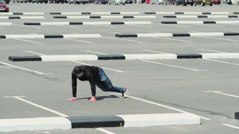 Young guy dancing hip hop in the car parking. Slow motion Stock Footage 138808510