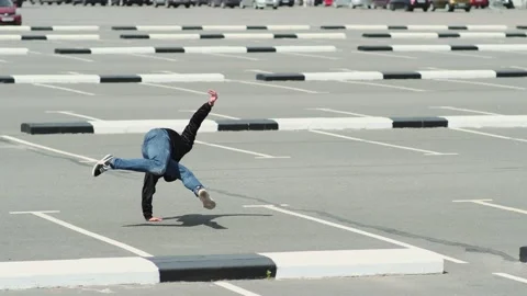 Young guy dancing hip hop in the car parking. Slow motion Stock Footage 138808559