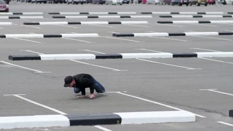 Young guy dancing hip hop in the car parking. Slow motion Stock Footage 138808583